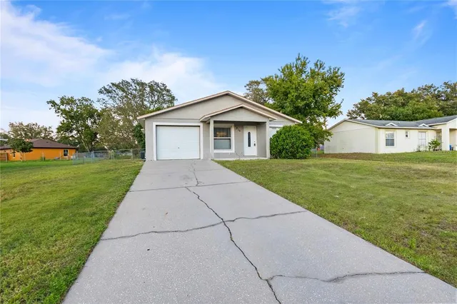 a view of backyard of house with green space