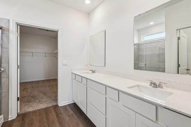 a bathroom with 2 sink and a mirror