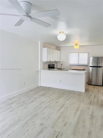 a kitchen with stainless steel appliances a refrigerator and a stove top oven
