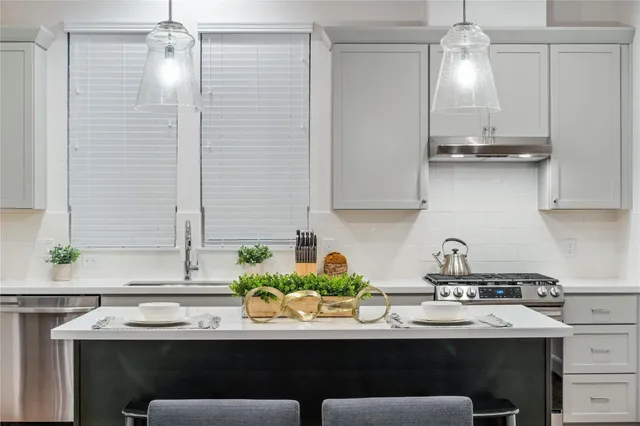 a kitchen with stainless steel appliances a sink and cabinets