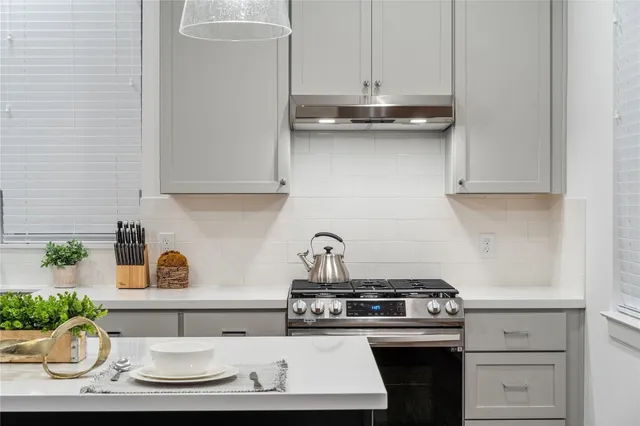 a kitchen with a stove and cabinets