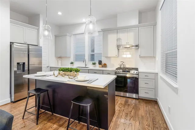a kitchen with a sink stove and refrigerator