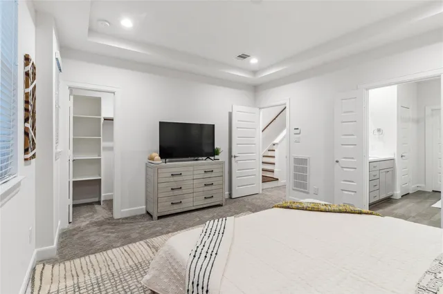 a bedroom with furniture and flat screen tv