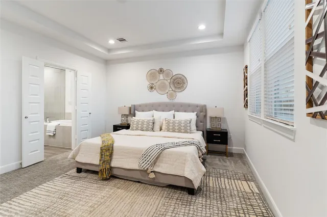 a bedroom with a large bed and a window