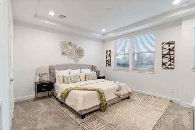 a bedroom with a large bed and a window