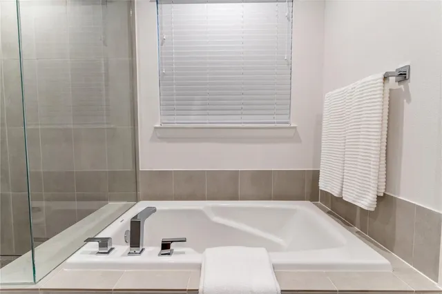 a bathroom with bathtub and window