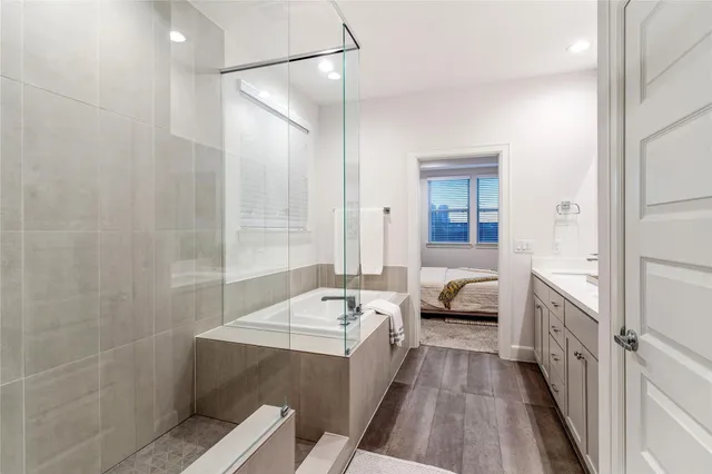 a en suite bathroom with a sink a large mirror and shower