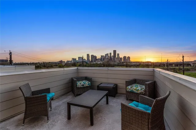 a view of a roof deck with furniture