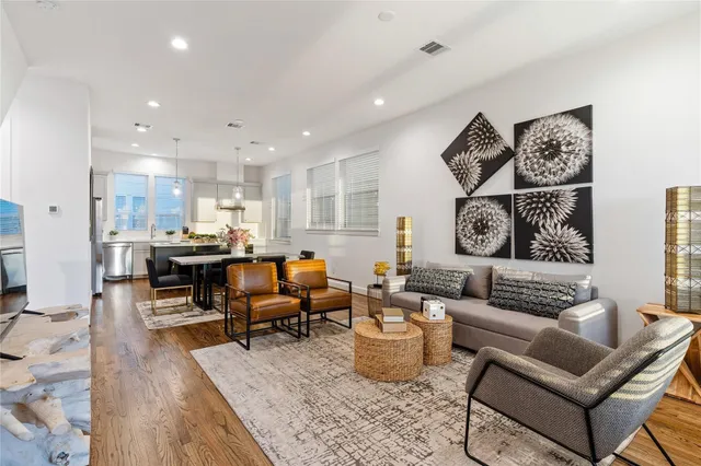 a living room with furniture kitchen view and a table