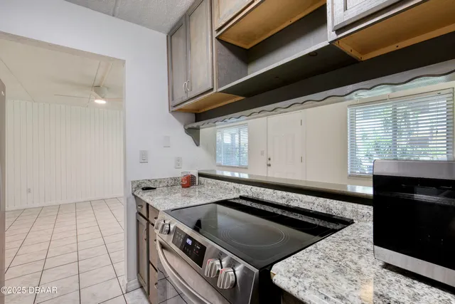 a kitchen that has a stove a sink and a microwave