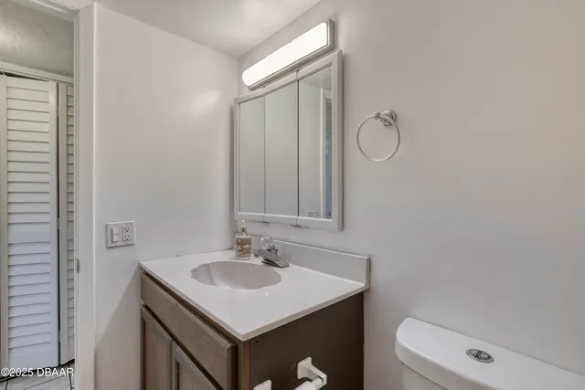 a bathroom with a sink vanity toilet and shower