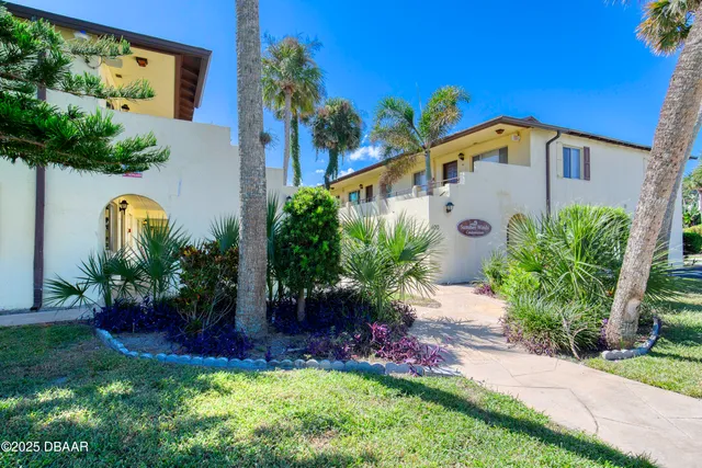 a view of a house with a yard and plants