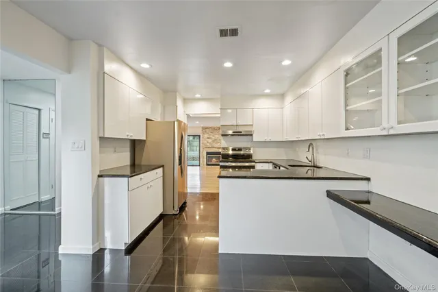 a kitchen with granite countertop a sink and cabinets