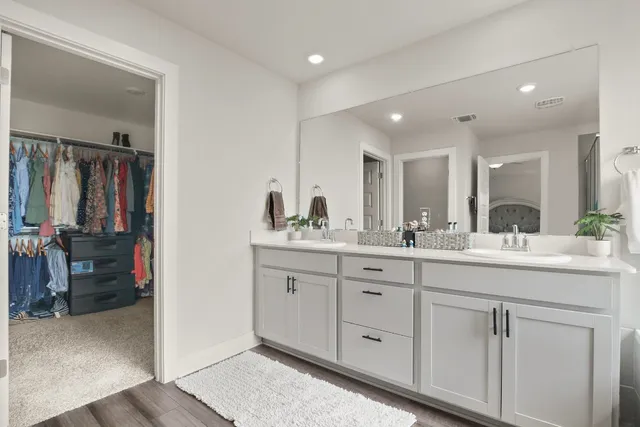 a bathroom with mirror and sink