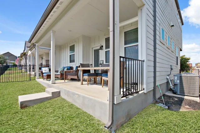 a view of a house with backyard porch and sitting area