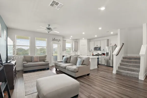 a living room with furniture and a large window