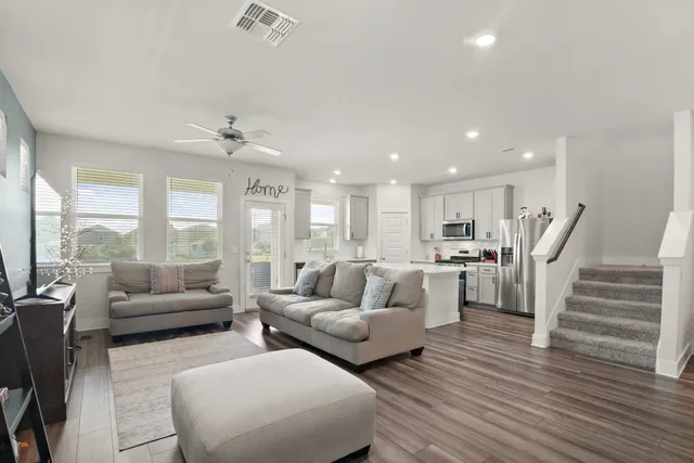 a living room with furniture and a large window