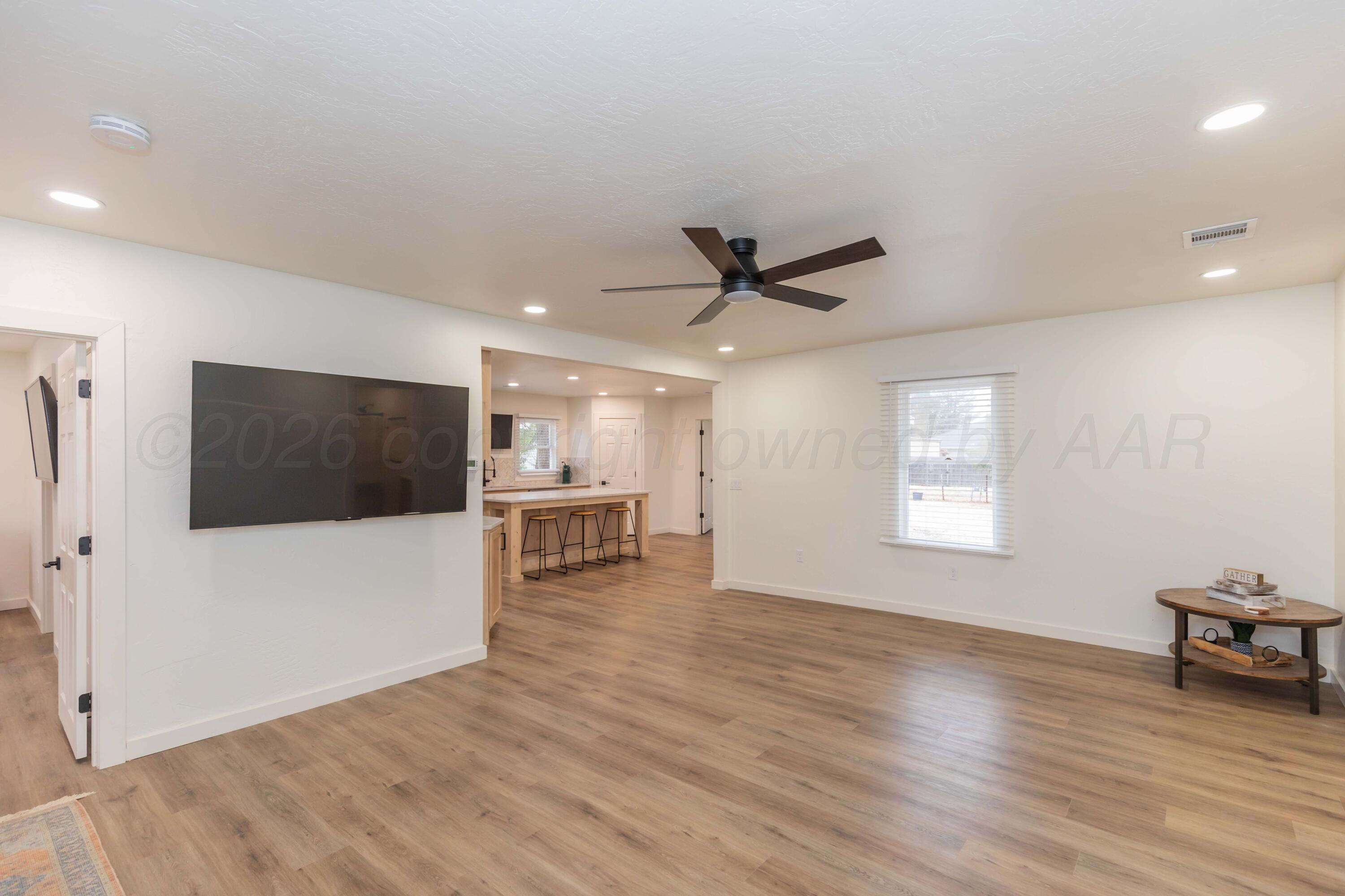 504 High Street Claude, TX 79019 - Photo 25 of 39 a view of a livingroom with a flat screen tv and wooden floor