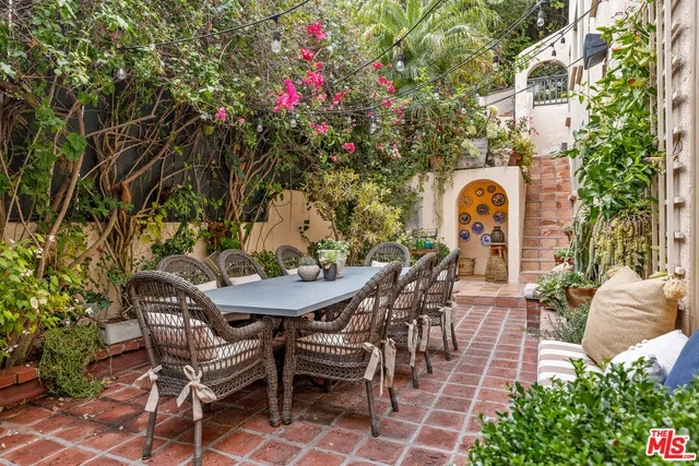 a backyard of a house with table and chairs