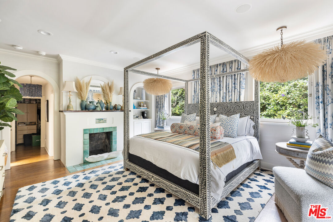 175 West Channel Road Santa Monica, CA 90402 - Photo 20 of 53 a bedroom with a bed and a fireplace