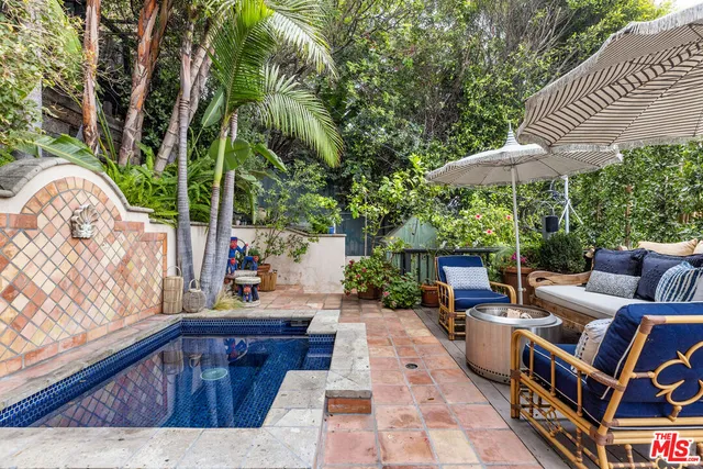 a backyard of a house with outdoor seating