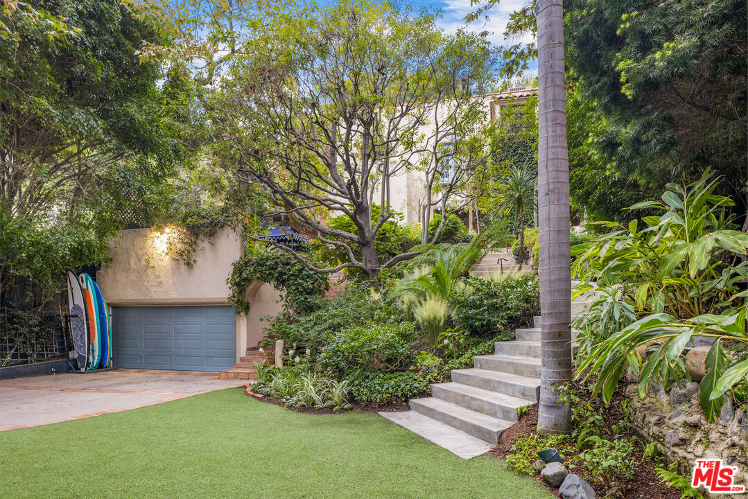175 West Channel Road Santa Monica, CA 90402 - Photo 36 of 53 a view of a yard with plants and a large tree