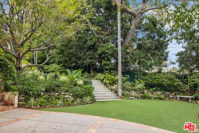 a view of two chairs and table in a patio