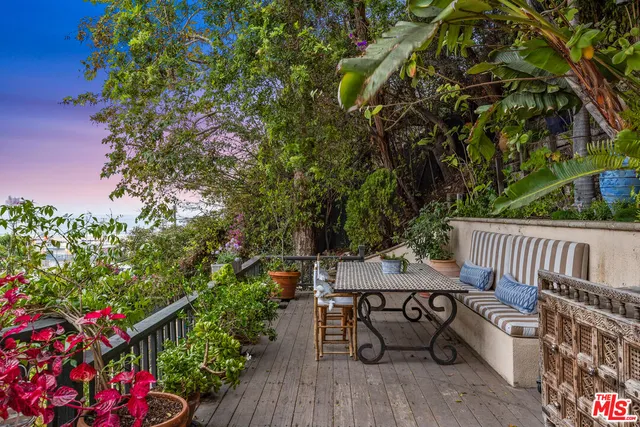 a outdoor space with patio couch and a potted plant