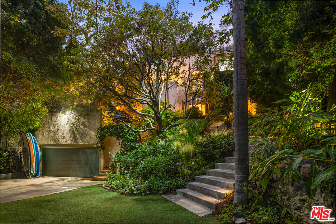 175 West Channel Road Santa Monica, CA 90402 - Photo 49 of 53 a view of a backyard with plants and large trees