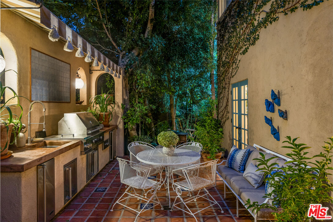 175 West Channel Road Santa Monica, CA 90402 - Photo 50 of 53 a view of a patio with table and chairs with wooden floor and fence