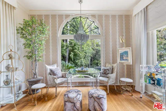 a living room with patio furniture and a large window