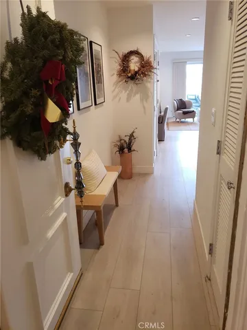 a living room with couches and projector with kitchen view