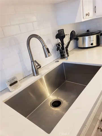 a kitchen with a sink and a stove