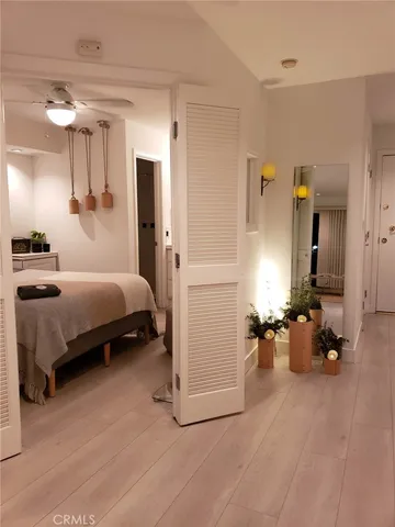 a bedroom with a bed and a night stand