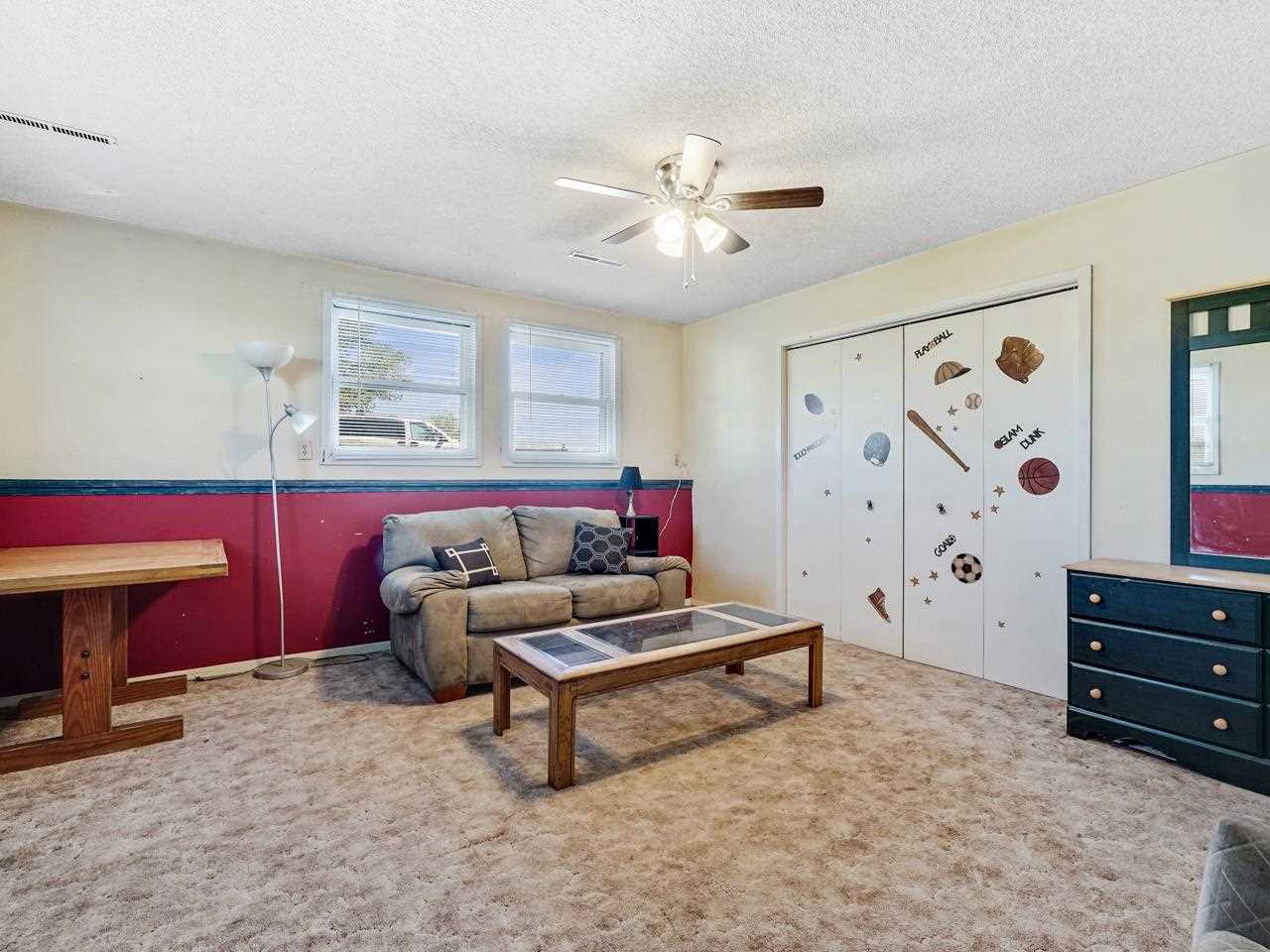 819 22 Road Grand Junction, CO 81505 - Photo 32 of 34 a living room with furniture and a dresser