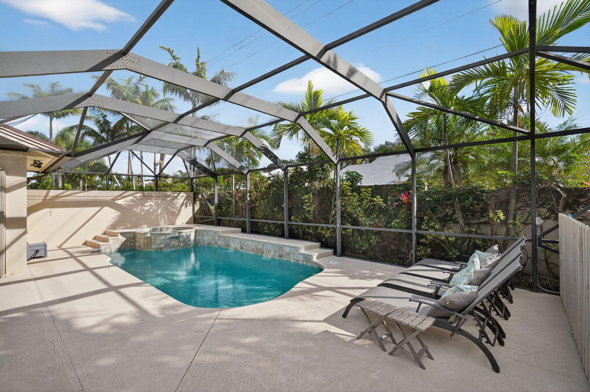121 Landward Drive Jupiter, FL 33477 - Photo 2 of 80 a backyard of a house with table and chairs