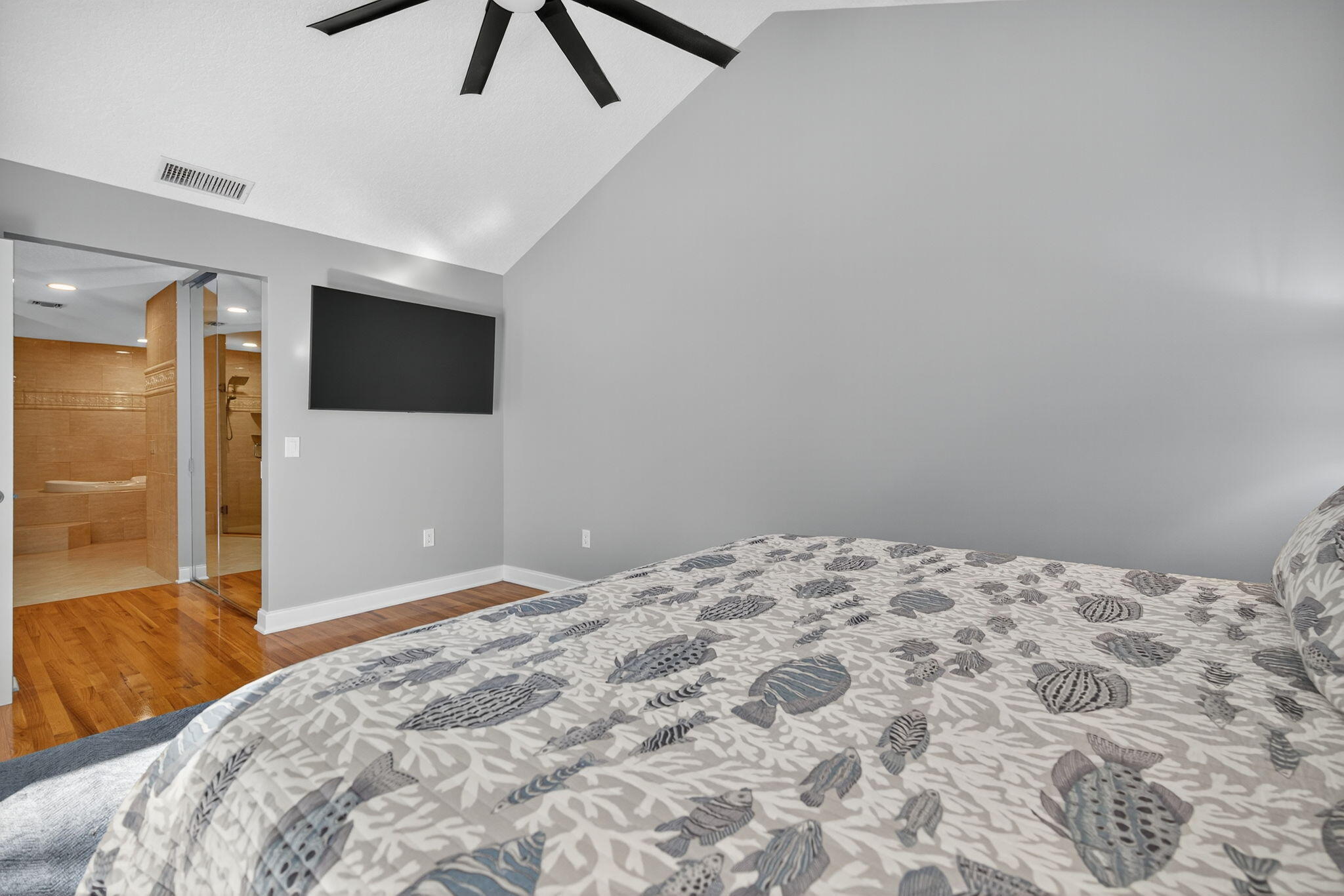 121 Landward Drive Jupiter, FL 33477 - Photo 29 of 80 a bedroom with a bed and a flat screen tv