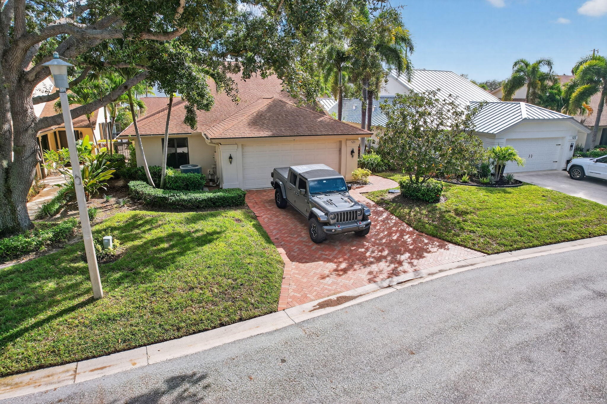 121 Landward Drive Jupiter, FL 33477 - Photo 65 of 80 a front view of a house with garden
