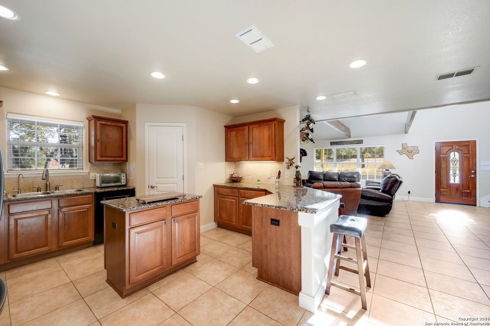 1367 Rolling Hills Road Blanco, TX 78606 - Photo 11 of 30 a kitchen with stainless steel appliances kitchen island granite countertop a stove and cabinets