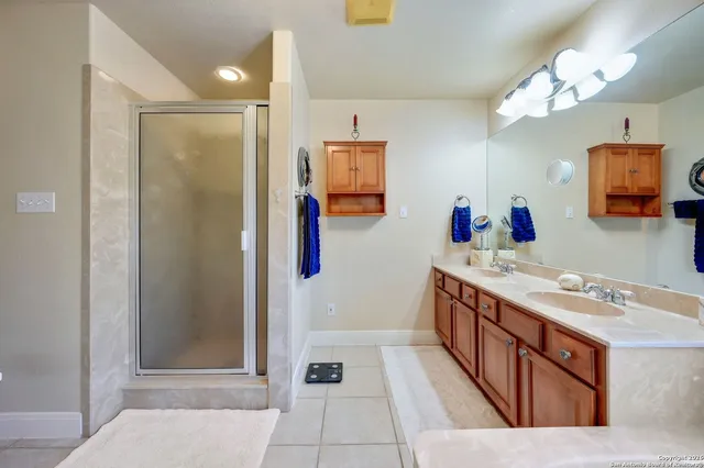 a bathroom with a tub sink and mirror