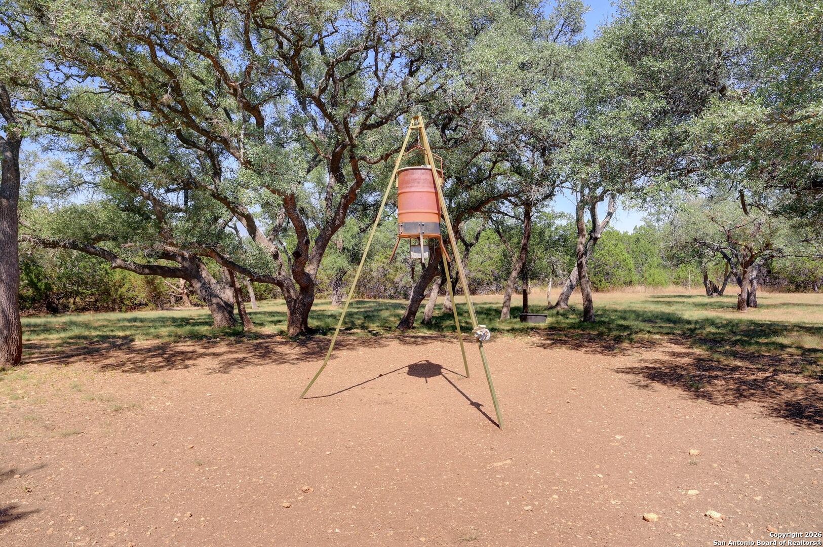 1367 Rolling Hills Road Blanco, TX 78606 - Photo 25 of 30 a wooden bench with a view of trees