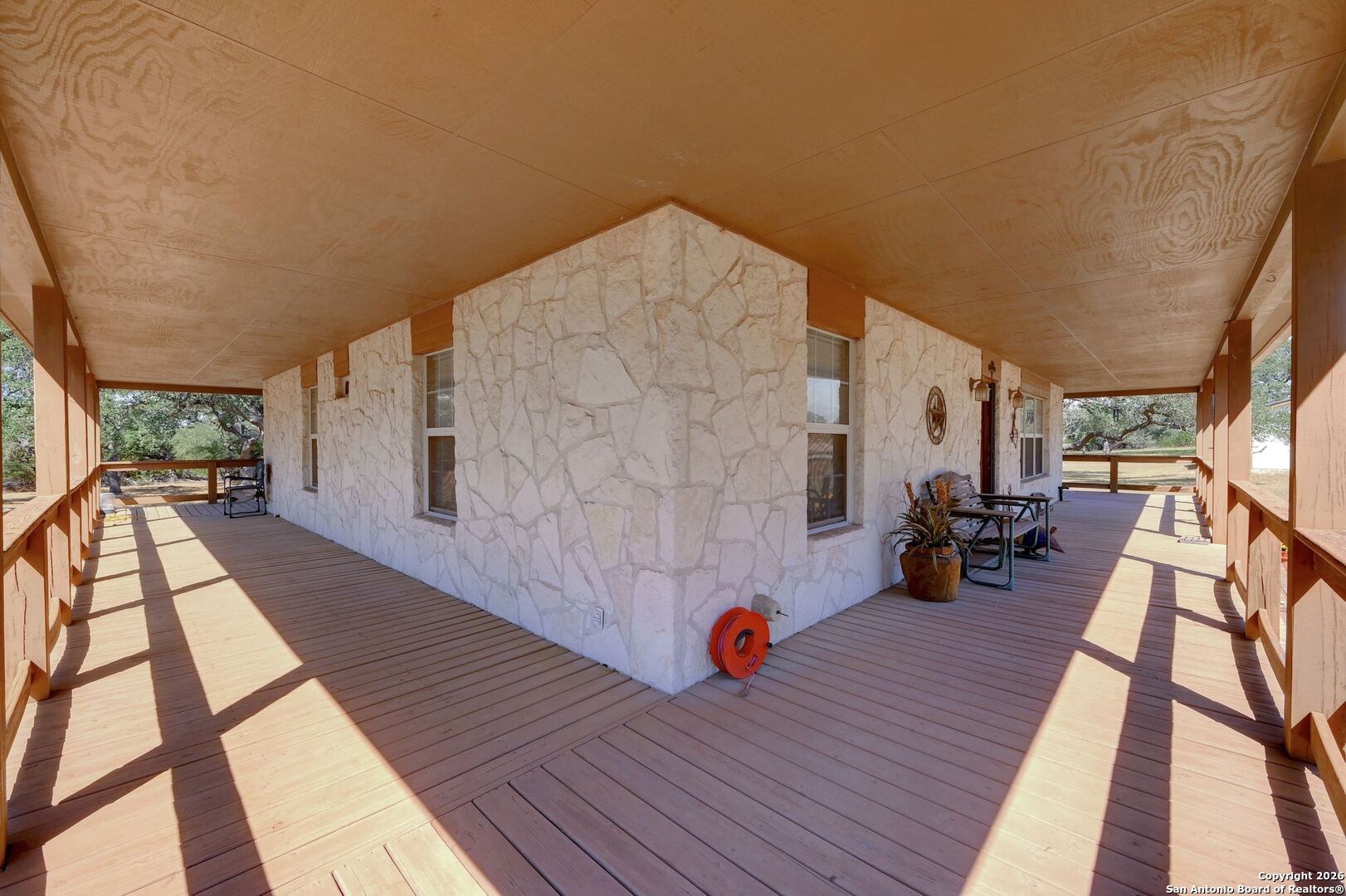 1367 Rolling Hills Road Blanco, TX 78606 - Photo 27 of 30 a view of a patio with wooden floor and iron stairs