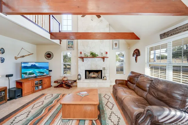 a living room with furniture and a fireplace