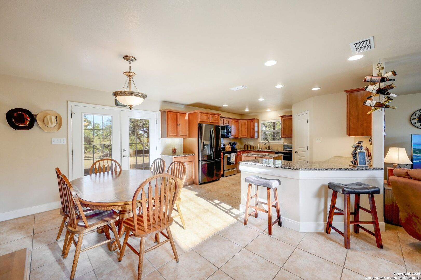 1367 Rolling Hills Road Blanco, TX 78606 - Photo 9 of 30 a view of a dining room with furniture and chandelier