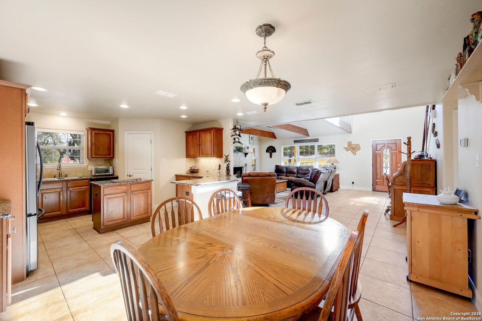 1367 Rolling Hills Road Blanco, TX 78606 - Photo 10 of 30 a view of a dining room and livingroom with furniture wooden floor a chandelier