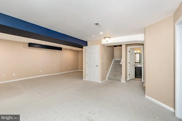 a bathroom with a granite countertop sink a toilet and shower