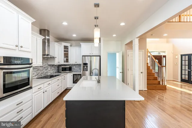 a view of a kitchen with a sink and large windows