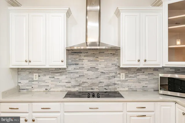 a kitchen with kitchen island granite countertop a sink a counter space appliances and cabinets