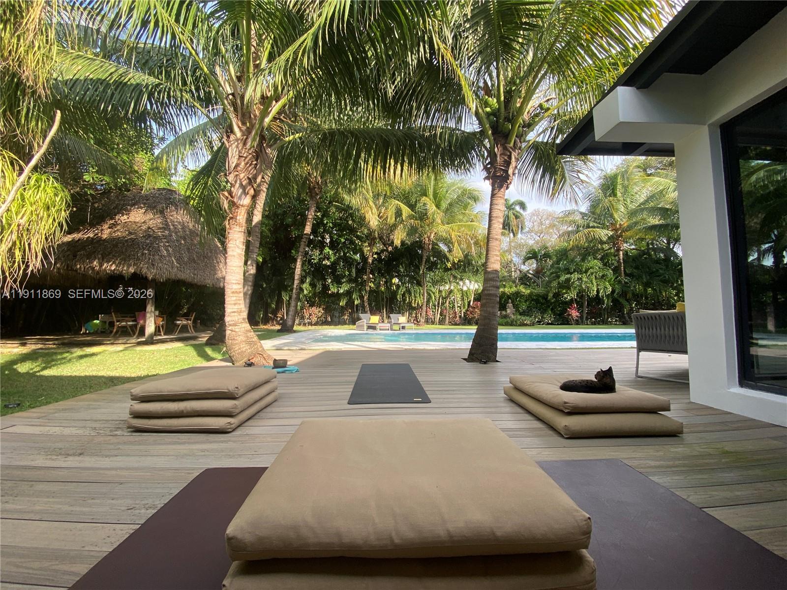 151 Northwest 87th Street El Portal, FL 33150 - Photo 12 of 19 a view of swimming pool with lounge chair and palm trees