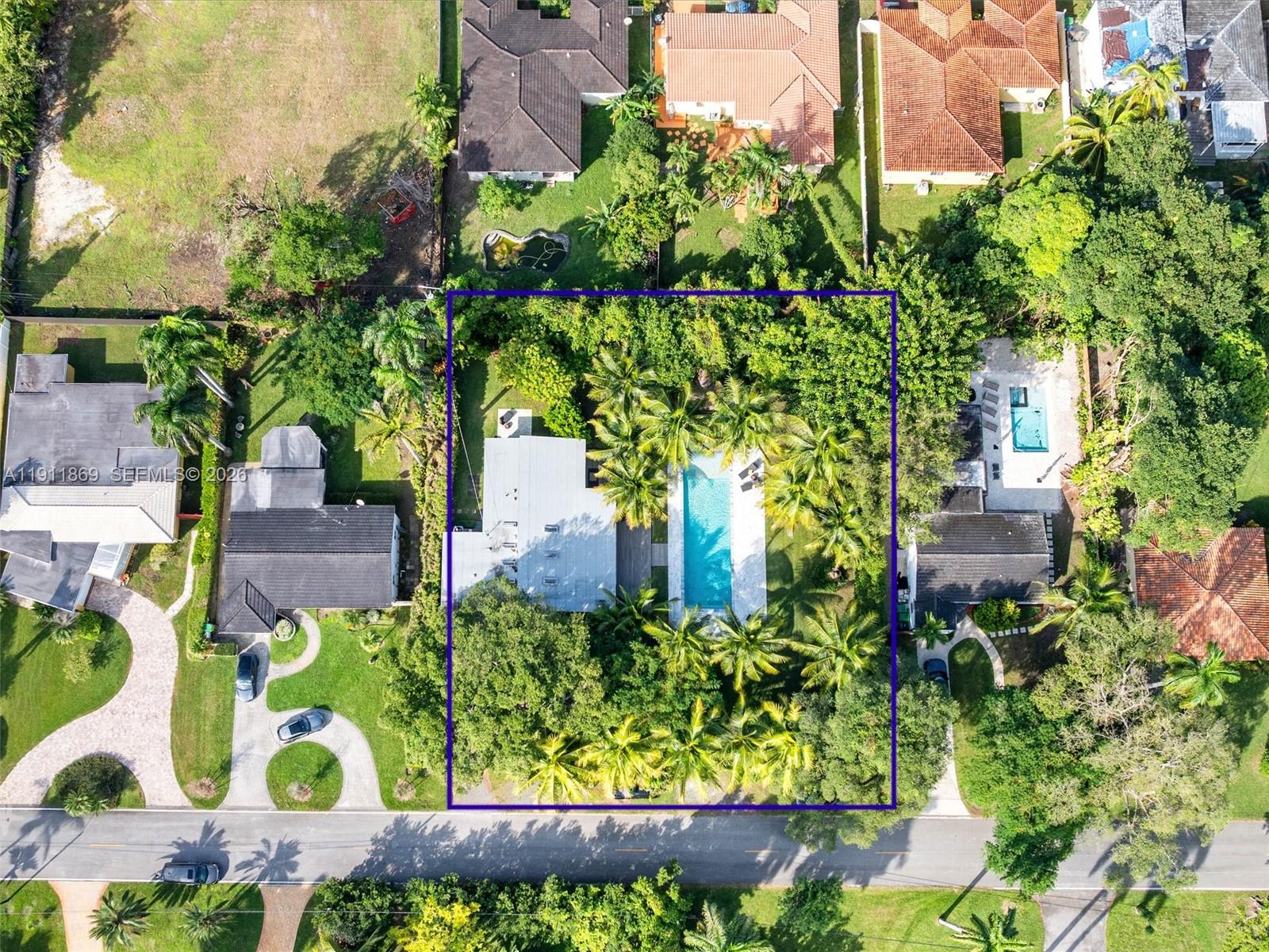151 Northwest 87th Street El Portal, FL 33150 - Photo 18 of 19 an aerial view of a house with a yard and garden in front of it